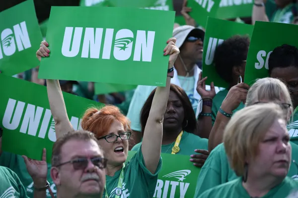 AFSCME member holding sign