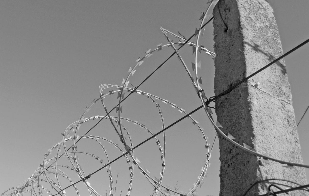 photo of barbed wire outside a prison